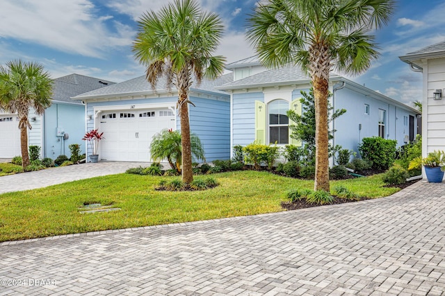 view of front of home with a front lawn and a garage