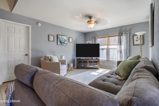 living room featuring light tile patterned floors and ceiling fan