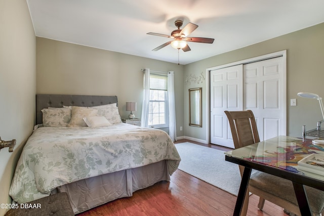 bedroom featuring hardwood / wood-style floors, ceiling fan, and a closet