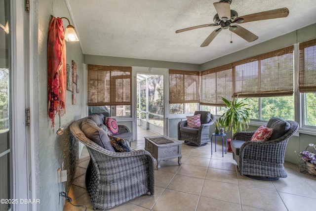 sunroom / solarium featuring ceiling fan