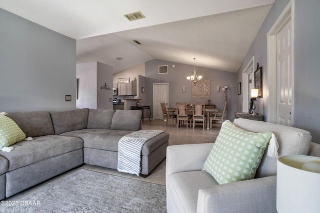 living room featuring a notable chandelier and vaulted ceiling