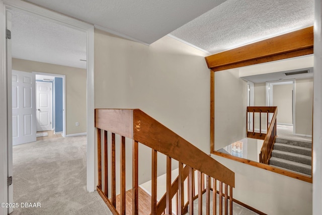 3824 Saxon Dr, New Smyrna Beach, FL 32169 - corridor with a textured ceiling, carpet, and an upstairs landing