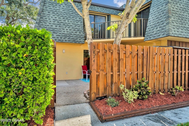 3824 Saxon Dr, New Smyrna Beach, FL 32169 - view of property exterior featuring roof with shingles and mansard roof