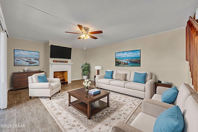 3824 Saxon Dr, New Smyrna Beach, FL 32169 - living room featuring wood finished floors, a ceiling fan, a fireplace, and crown molding