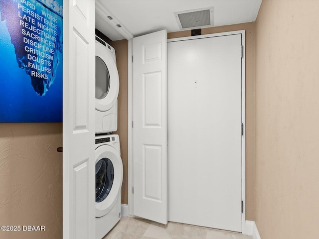 laundry area featuring stacked washer and dryer