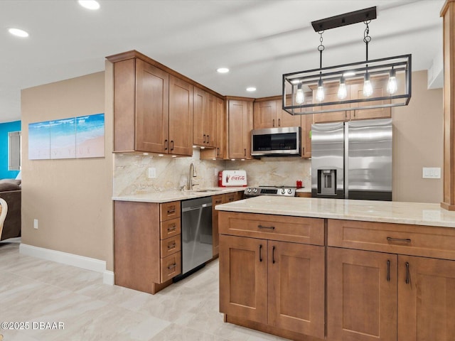 kitchen featuring sink, appliances with stainless steel finishes, light stone countertops, decorative backsplash, and decorative light fixtures