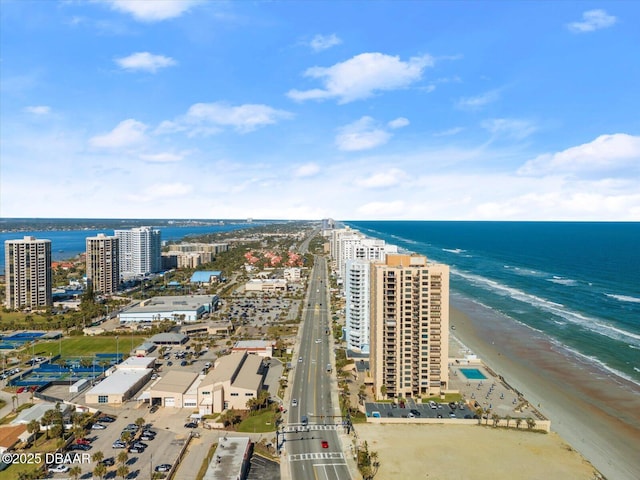 drone / aerial view with a water view and a beach view