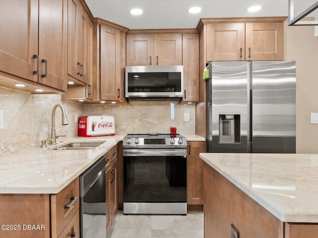 kitchen featuring tasteful backsplash, sink, stainless steel appliances, and light stone countertops