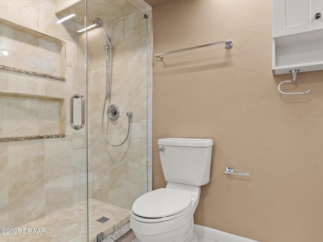 bathroom featuring toilet and an enclosed shower