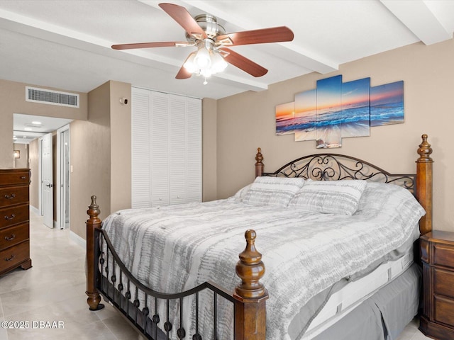 bedroom with ceiling fan, a closet, and beamed ceiling