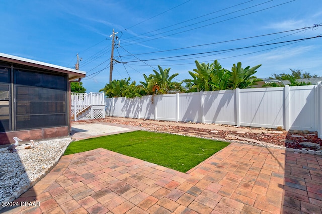 view of yard featuring a patio area and a sunroom