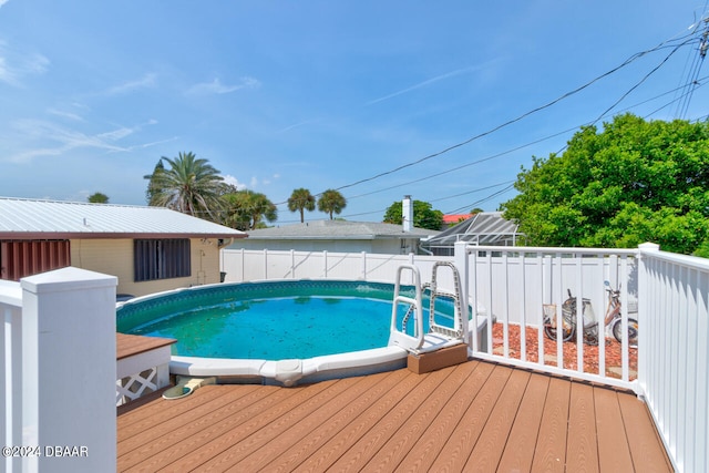 view of swimming pool featuring a wooden deck