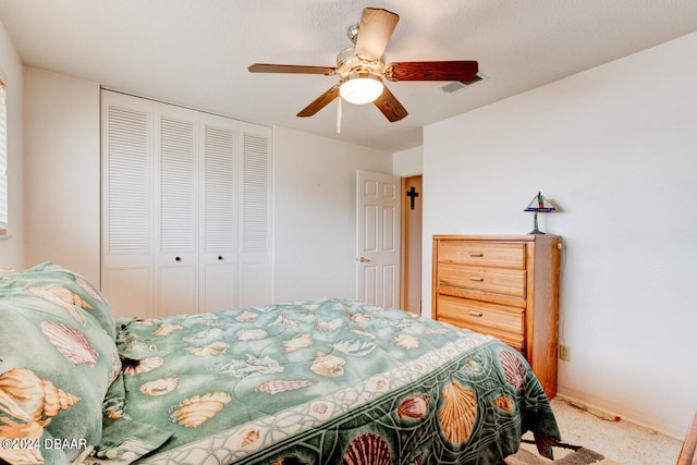 carpeted bedroom with ceiling fan and a closet