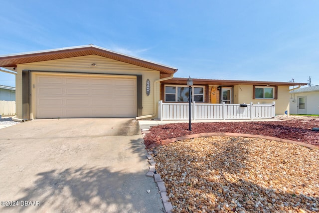 ranch-style house featuring a porch and a garage