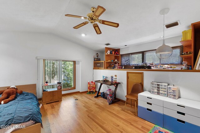 bedroom featuring light hardwood / wood-style floors, ceiling fan, multiple windows, and vaulted ceiling