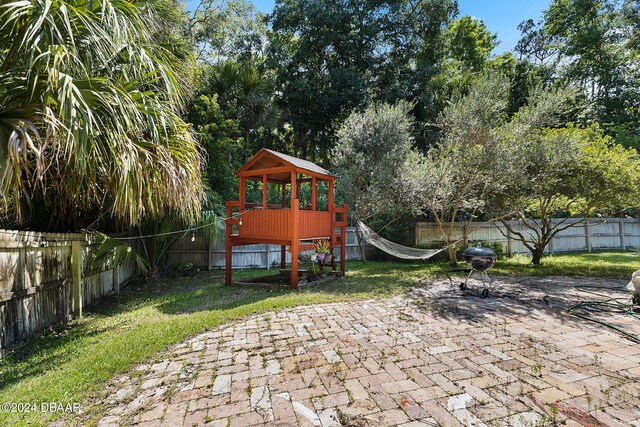 view of play area featuring a yard and a patio area