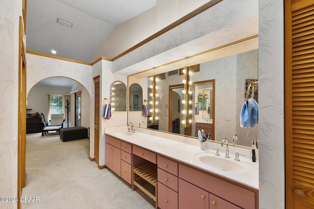 bathroom with vanity and vaulted ceiling