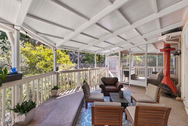 sunroom featuring vaulted ceiling