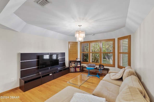 living room featuring wood-type flooring and a chandelier