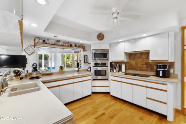 kitchen featuring white cabinets, light wood-type flooring, stainless steel appliances, and sink