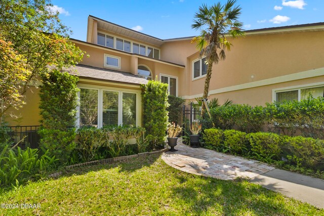 view of front of home with a front lawn and a patio area