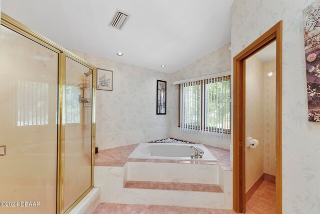 bathroom with vaulted ceiling, tile patterned floors, and separate shower and tub