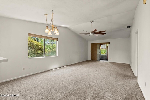 carpeted empty room with visible vents, baseboards, vaulted ceiling, and ceiling fan with notable chandelier