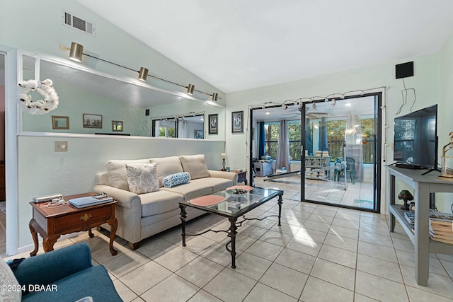 living room with lofted ceiling, light tile patterned floors, and french doors