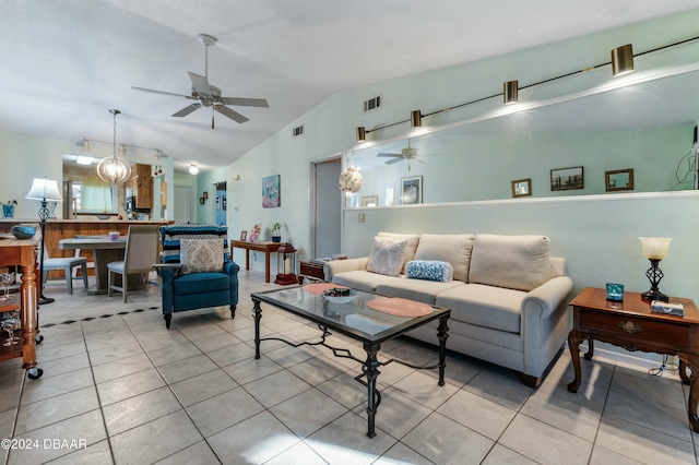 living room with light tile patterned floors, ceiling fan, and lofted ceiling