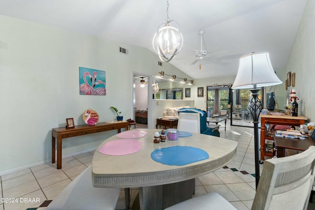 dining area featuring light tile patterned floors, ceiling fan with notable chandelier, and vaulted ceiling