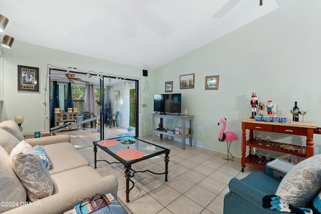 living room featuring ceiling fan, light tile patterned floors, and vaulted ceiling