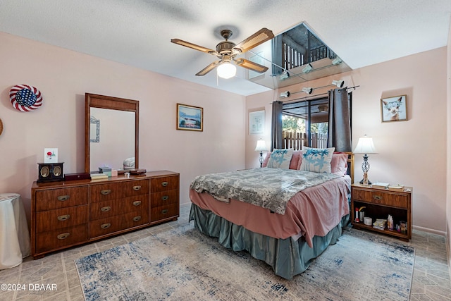 bedroom with ceiling fan and a textured ceiling