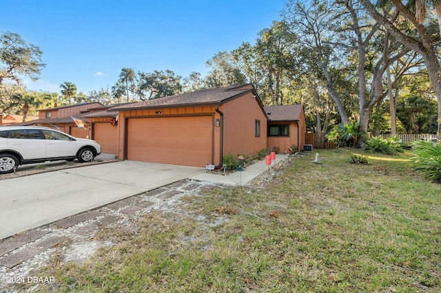 view of property exterior with a yard and a garage