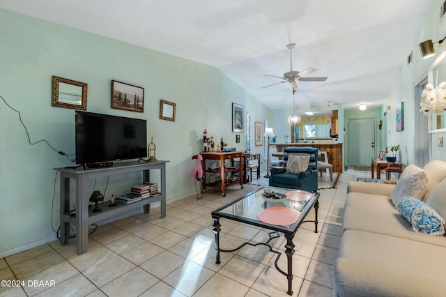 tiled living room featuring ceiling fan and vaulted ceiling