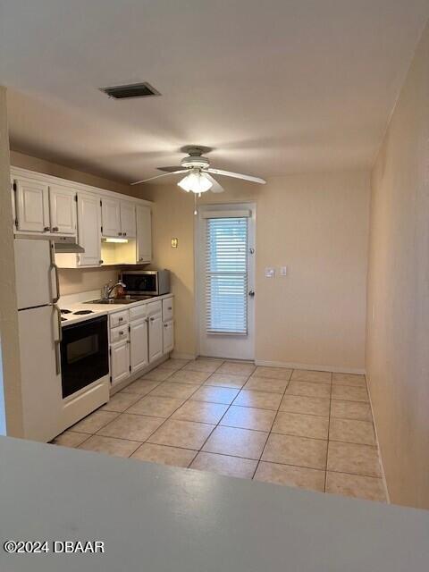 kitchen with white cabinetry, sink, ceiling fan, light tile patterned floors, and white appliances