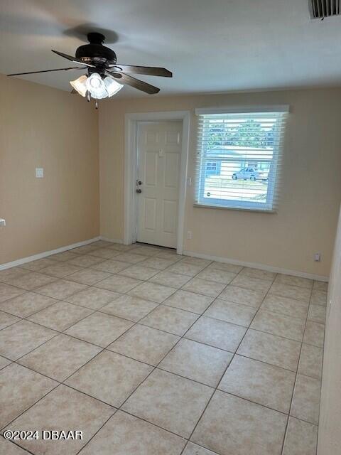entryway featuring a ceiling fan, light tile patterned flooring, and baseboards