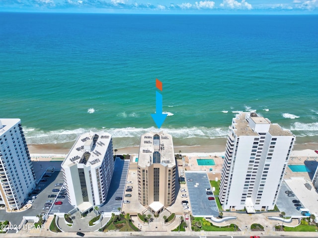 birds eye view of property with a beach view and a water view