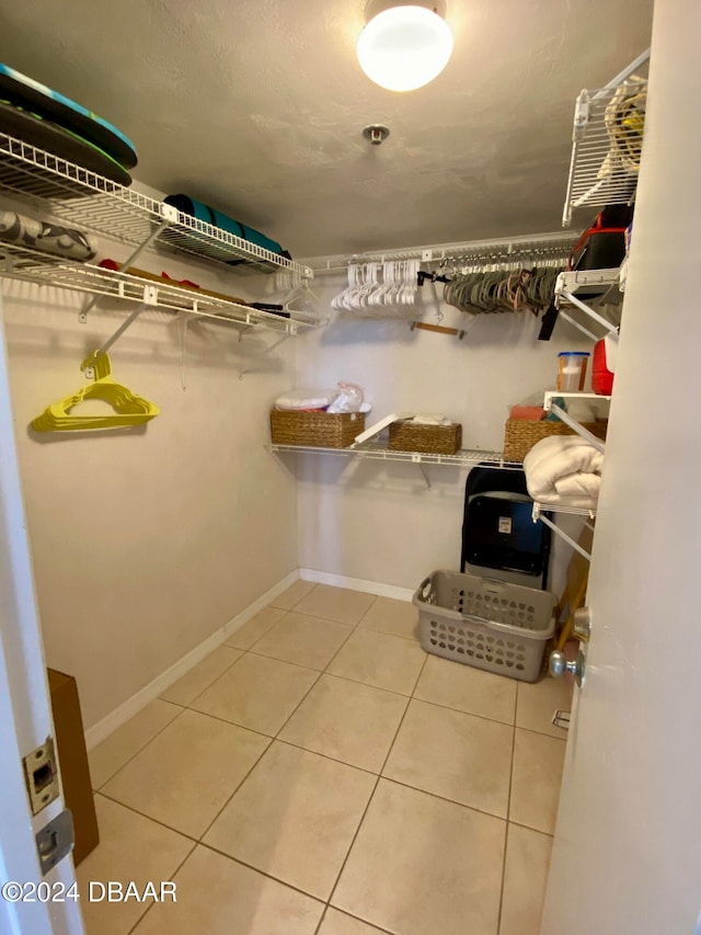 spacious closet with tile patterned floors