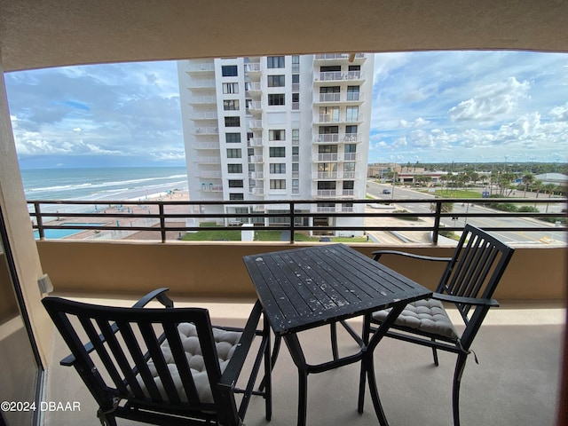 balcony with a water view and a beach view