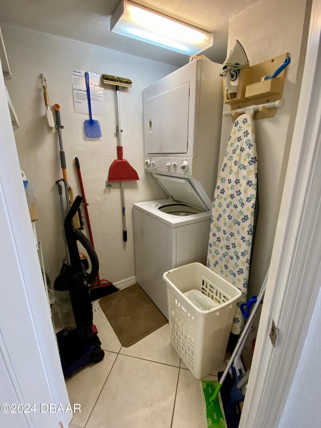 3023 S Atlantic Ave Unit 4070, Daytona Beach Shores, FL 32118 - laundry room featuring stacked washer / dryer and light tile patterned floors