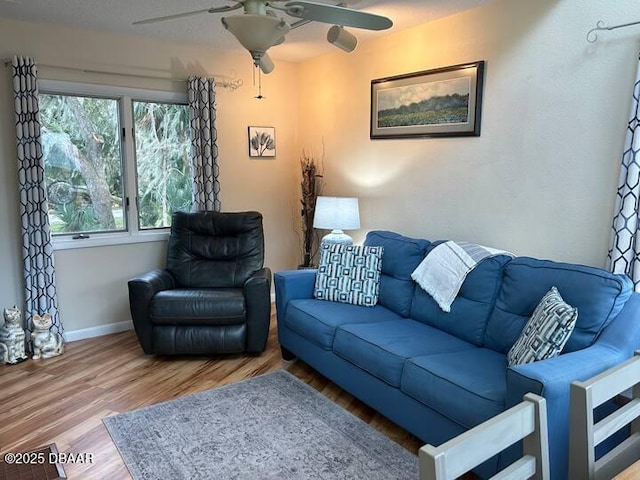 21951 Tarragona Way, Astor, FL 32102 - living area with a ceiling fan, wood finished floors, and baseboards