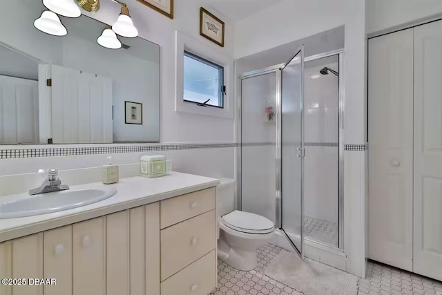 21951 Tarragona Way, Astor, FL 32102 - full bath featuring vanity, a stall shower, toilet, and tile patterned flooring