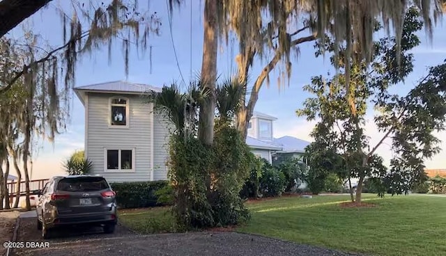 21951 Tarragona Way, Astor, FL 32102 - view of side of home featuring a yard
