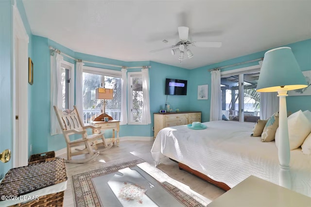 21951 Tarragona Way, Astor, FL 32102 - bedroom featuring baseboards, wood finished floors, ceiling fan, and access to outside