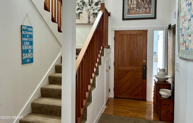21951 Tarragona Way, Astor, FL 32102 - foyer featuring stairs, wood finished floors, and a barn door