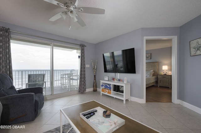 1183 Ocean Shore Blvd Unit 602, Ormond Beach, FL 32176 - living room with light tile patterned flooring, ceiling fan, and baseboards