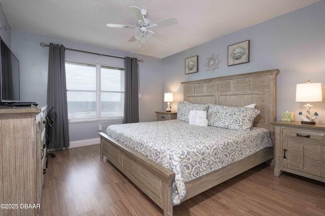 1183 Ocean Shore Blvd Unit 602, Ormond Beach, FL 32176 - bedroom featuring wood finished floors, baseboards, ceiling fan, and a textured ceiling