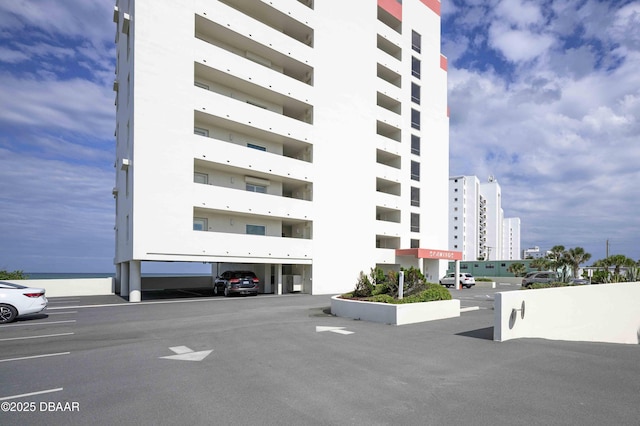 1183 Ocean Shore Blvd Unit 602, Ormond Beach, FL 32176 - view of apartment building / complex featuring parking