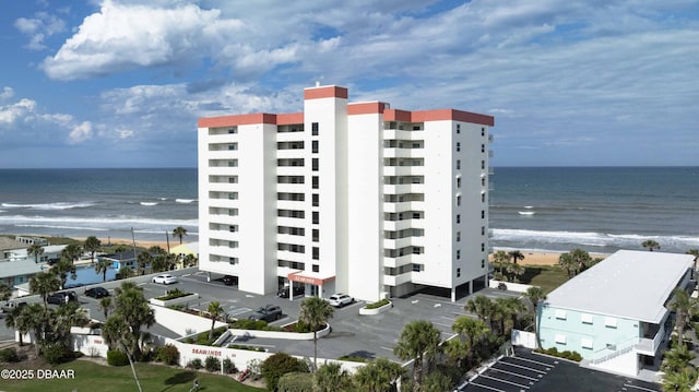 1183 Ocean Shore Blvd Unit 602, Ormond Beach, FL 32176 - view of apartment building / complex with view of water and beach and uncovered parking
