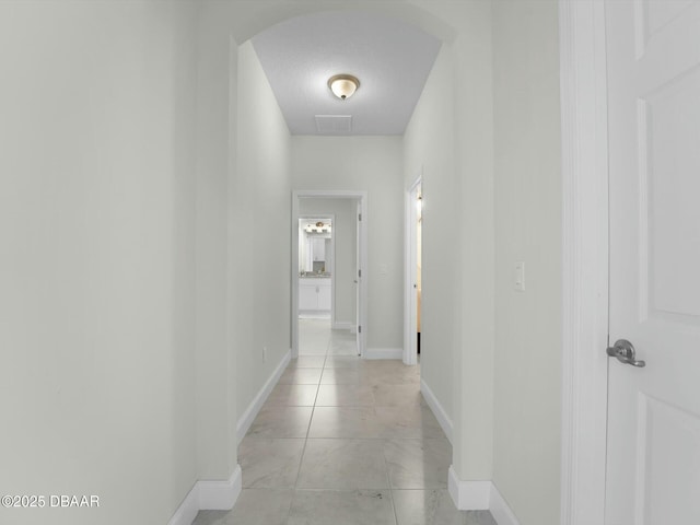 hall with a textured ceiling